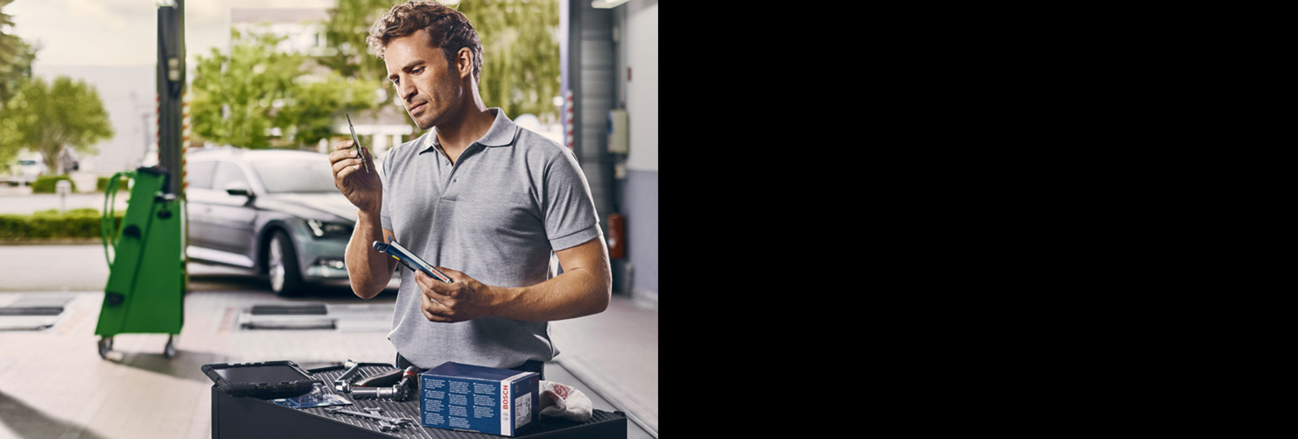 Man holding glow plugs in garage